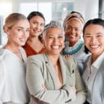 A multicultural group of women showing the benefits of DEI allyship in the workplace