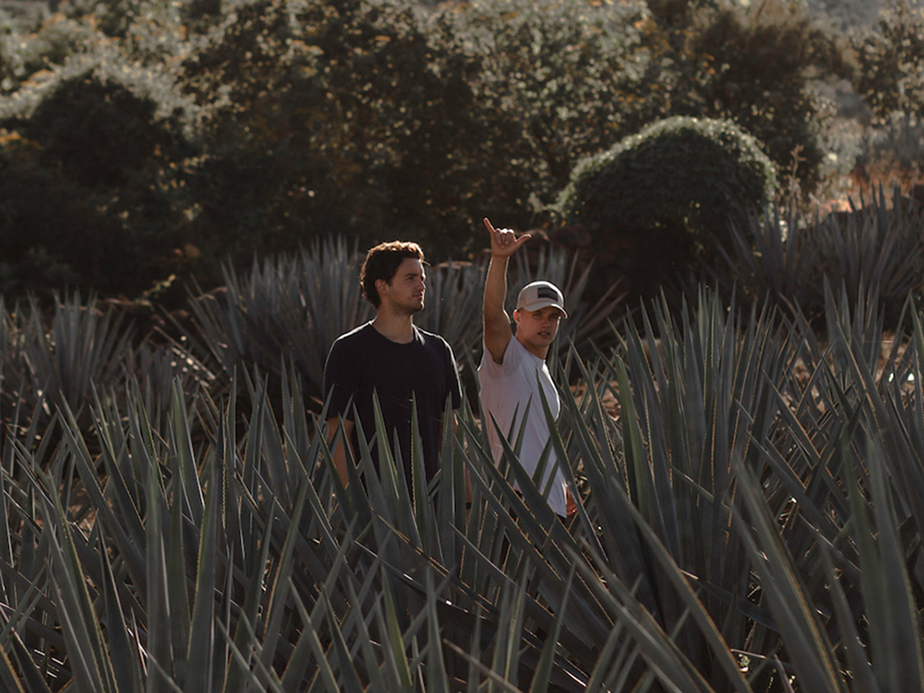 Carlos soto and Michael Arbanas in a mezcal field