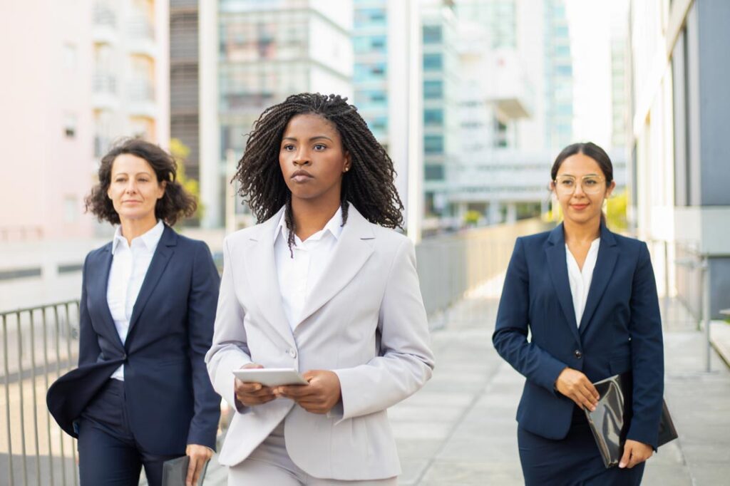 three confident business women exemplifying microfeminism in the workplace