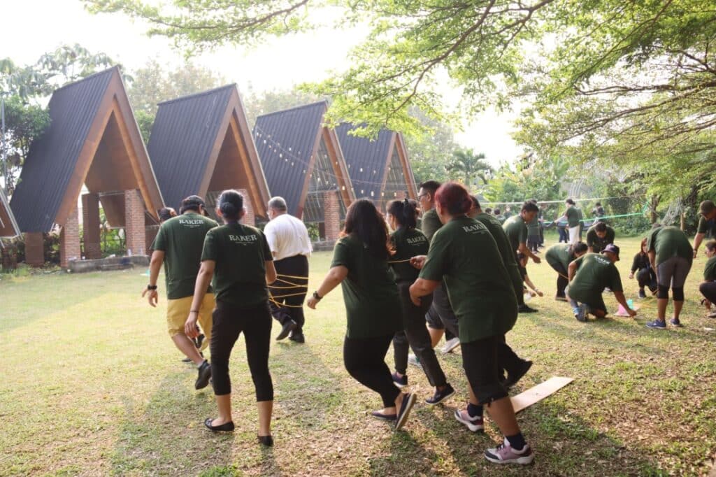 A group of people engaged in a team-building exercise at a company retreat