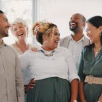 a group of people standing together and smiling at one another