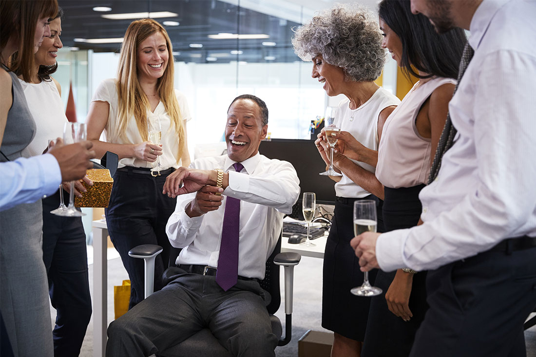 Coworkers celebrating gift giving in the workplace