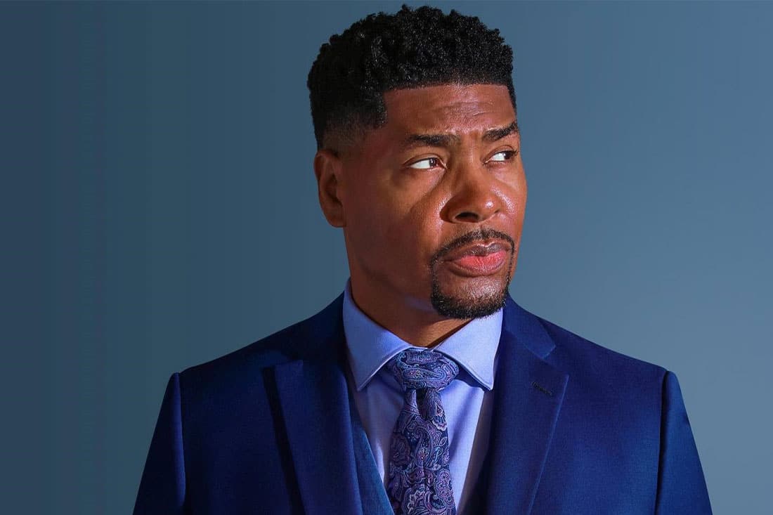 headshot of Tariq Nasheed in blue suit with blue backdrop