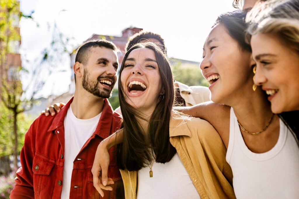 a group of people smiling and laughing together