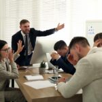 boss screaming at employees in a toxic work culture