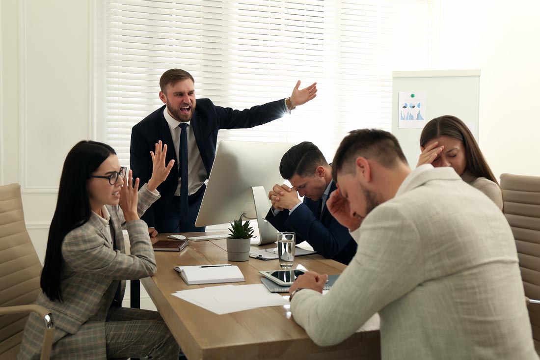 boss screaming at employees in a toxic work culture