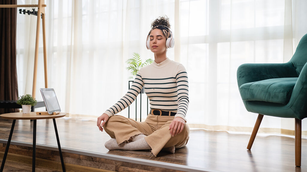 woman meditating with headphones on