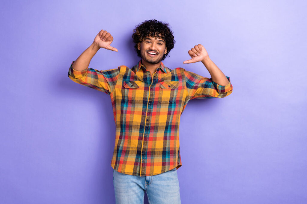 Young man points at himself exemplifying branding yourself