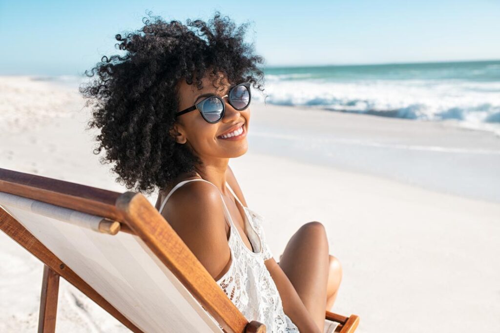 Happy young women on the beach exemplifying mood elevator