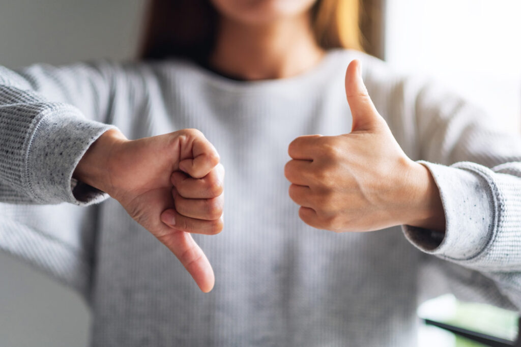 Women with thumbs up and down exemplifying the entrepreneur roller coaster