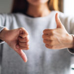 Women with thumbs up and down exemplifying the entrepreneur roller coaster