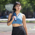 Britney Wittes holding a tennis racket