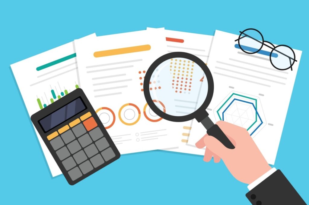 A graphic of a magnifying glass and a calculator on top of a pile of charts and data.