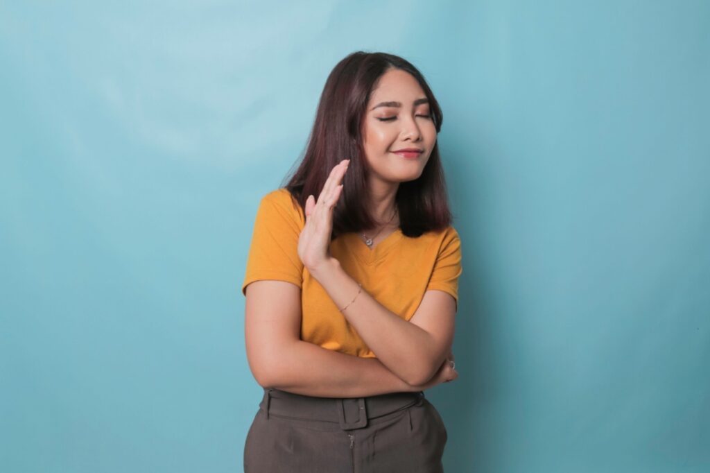 A woman holds up her hand to gesture "no."