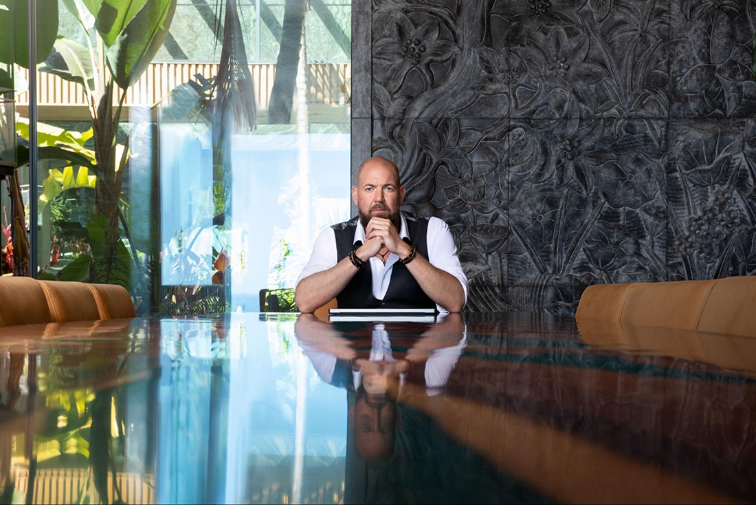 Dalton Locke sitting at a conference table