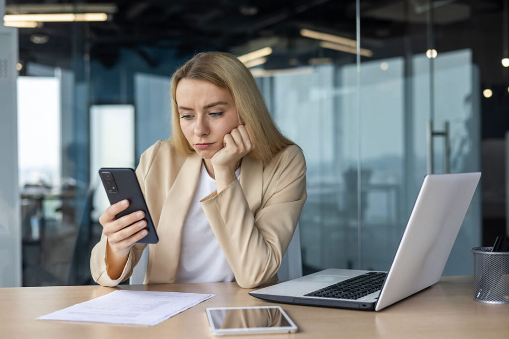 Sad and disappointed woman at workplace inside office