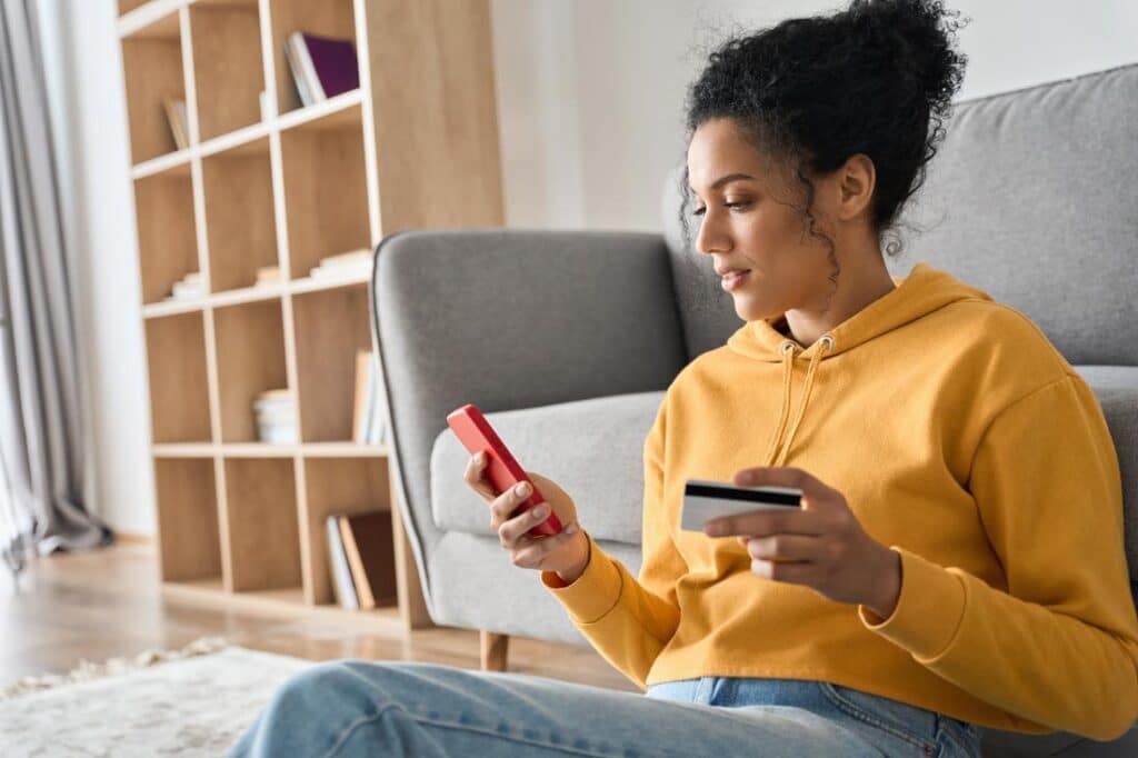 Women at home on her phone using empower budget app