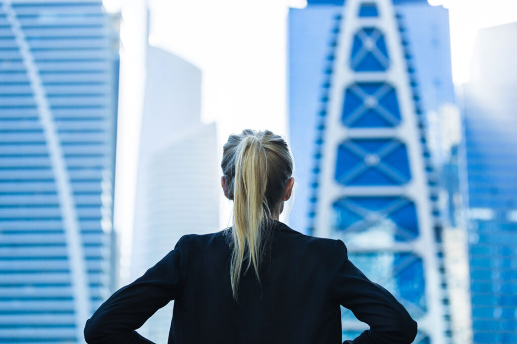 professional women looking up at skyscrapers