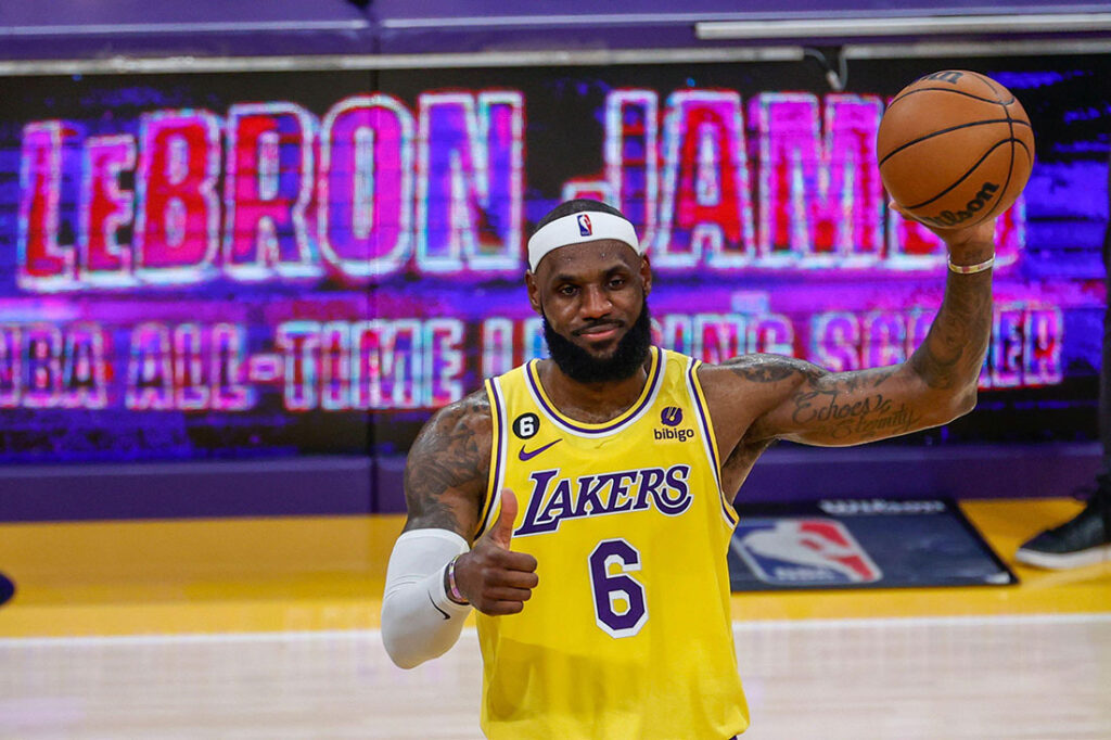 lebron james on the basketball court with a lakers jersey and basketball