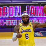 lebron james on the basketball court with a lakers jersey and basketball