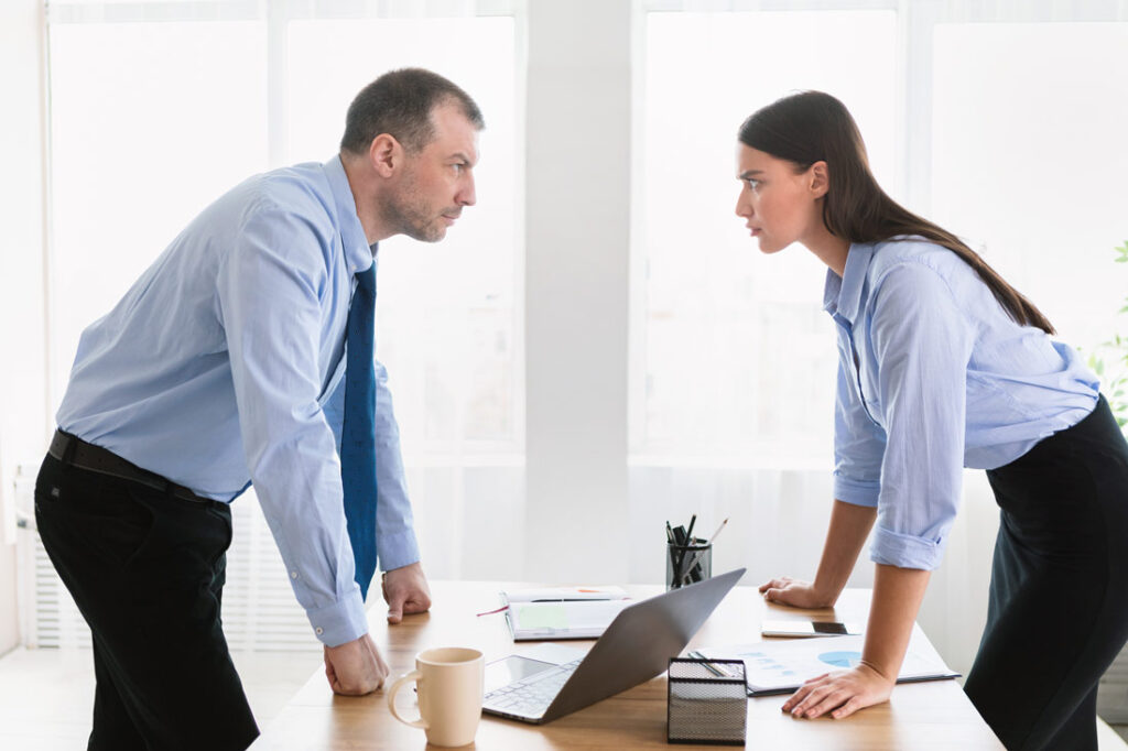 two colleagues face off exemplifying outsmarting a narcissist at the office