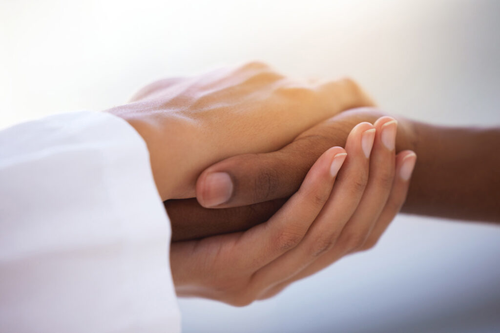 Two women holding hands exemplifying healing a relationship