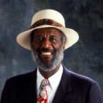 headshot of wally amos with gray backdrop