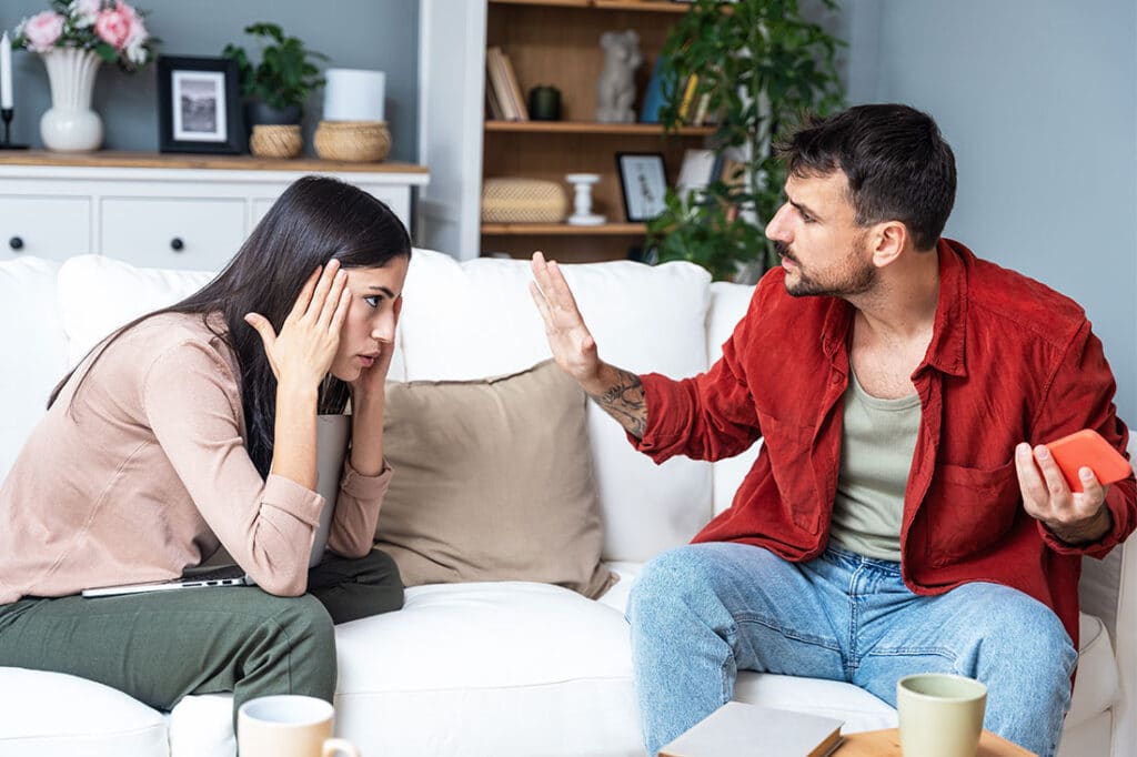 Young couple at home having a tense conversation