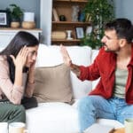 Young couple at home having a tense conversation