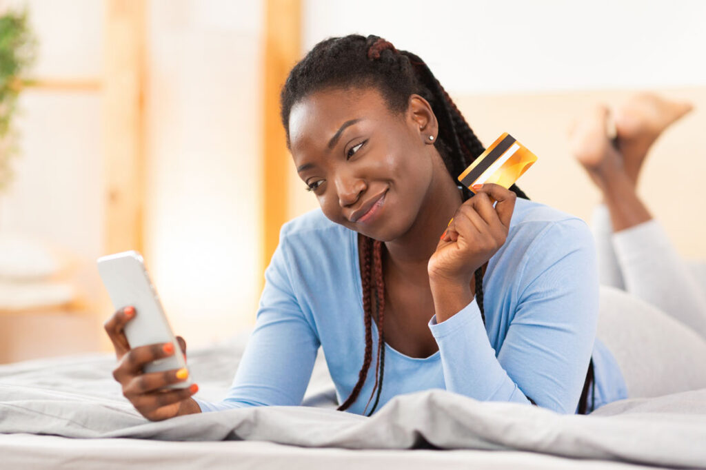 happy women using the ynab app on her phone