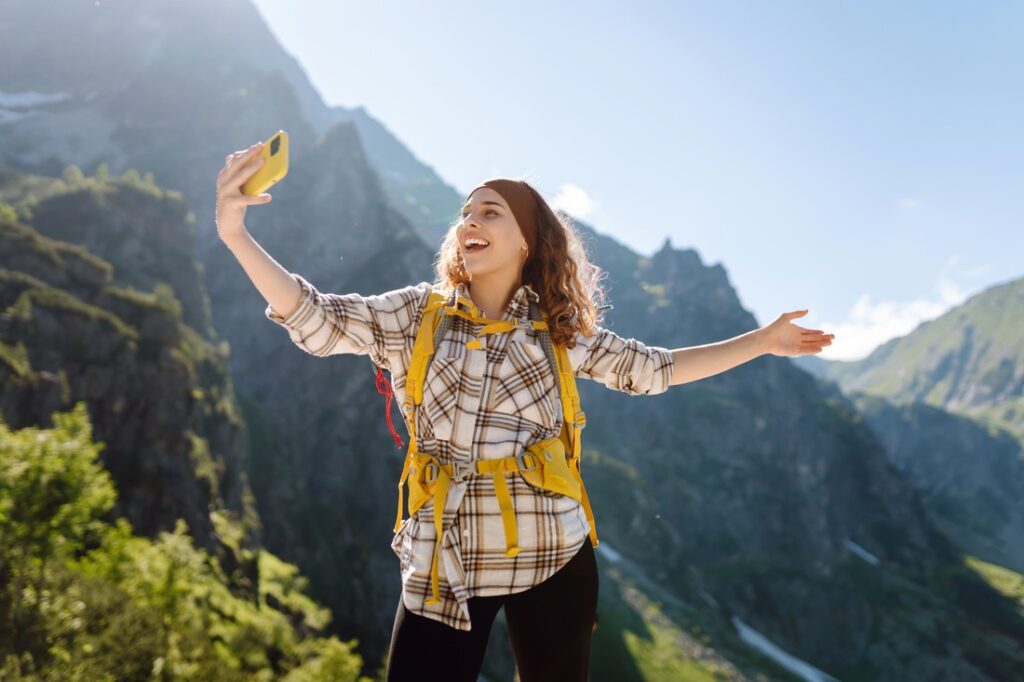 woman taking a selfie while on a mountain