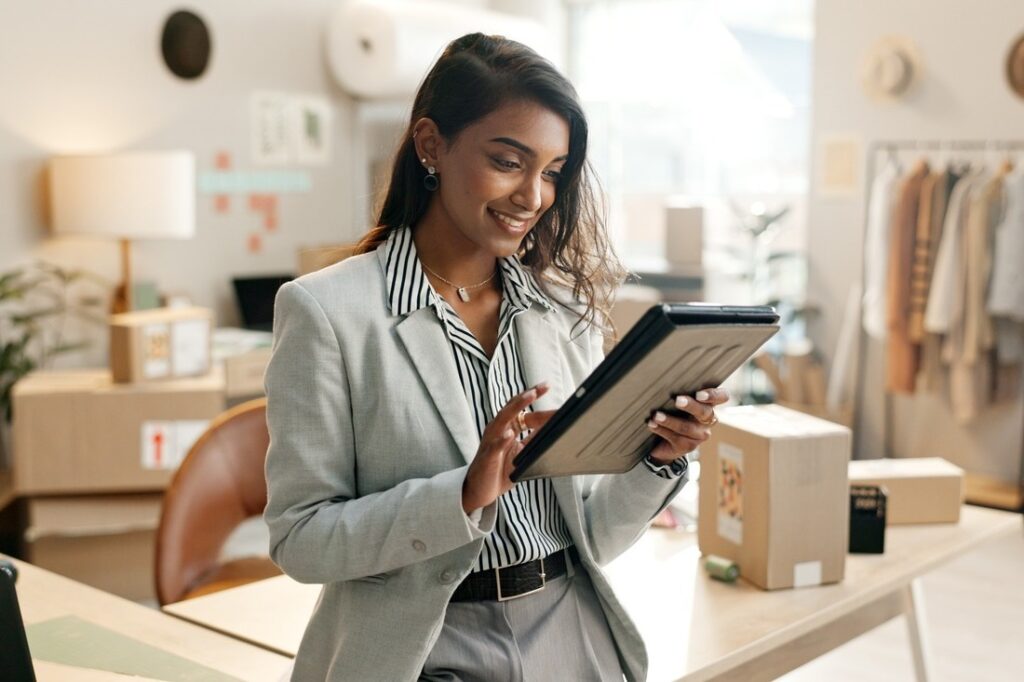 business owner using a tablet device while in her office