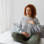 women practicing breathing exercises as breathwork