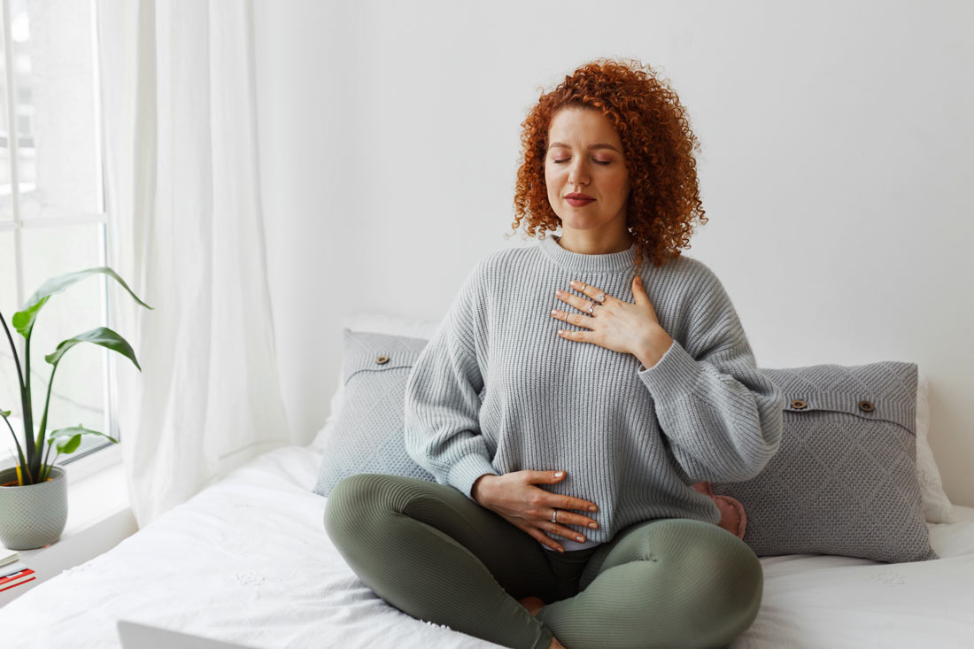 women practicing breathing exercises as breathwork