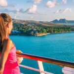 young women looks out from the deck of a Caribbean cruise ship