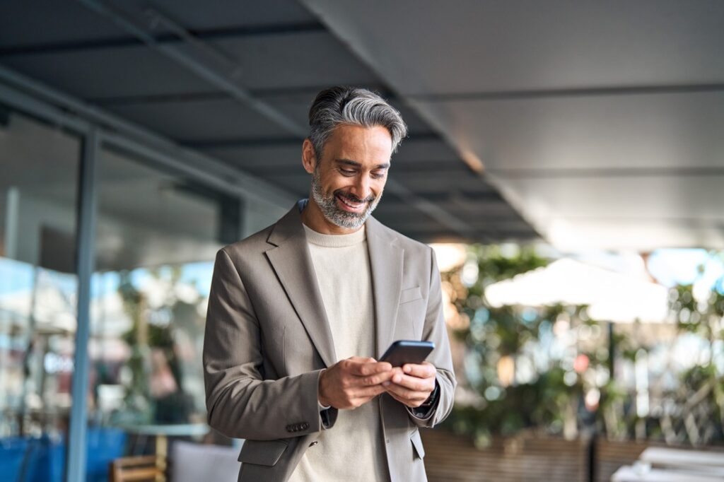 businessman smiling at his phone