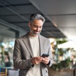 businessman smiling at his phone