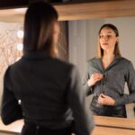 confident women looks at herself in a mirror