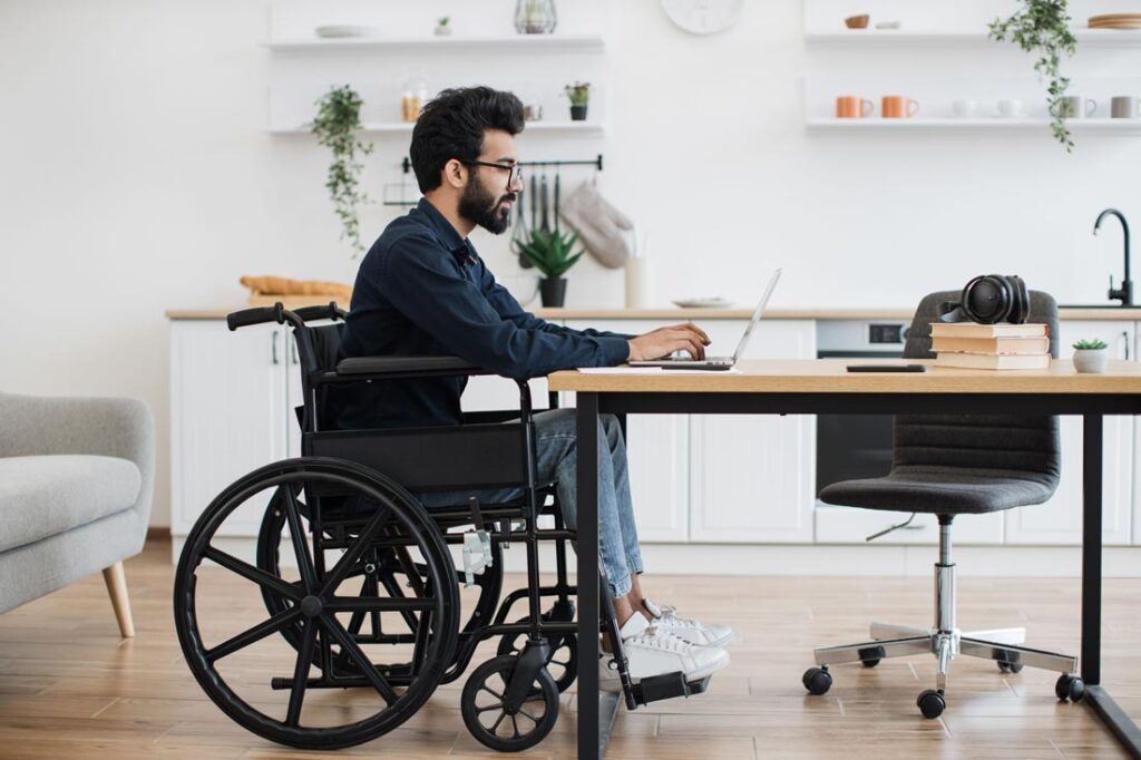 young disabled man working remotely at home