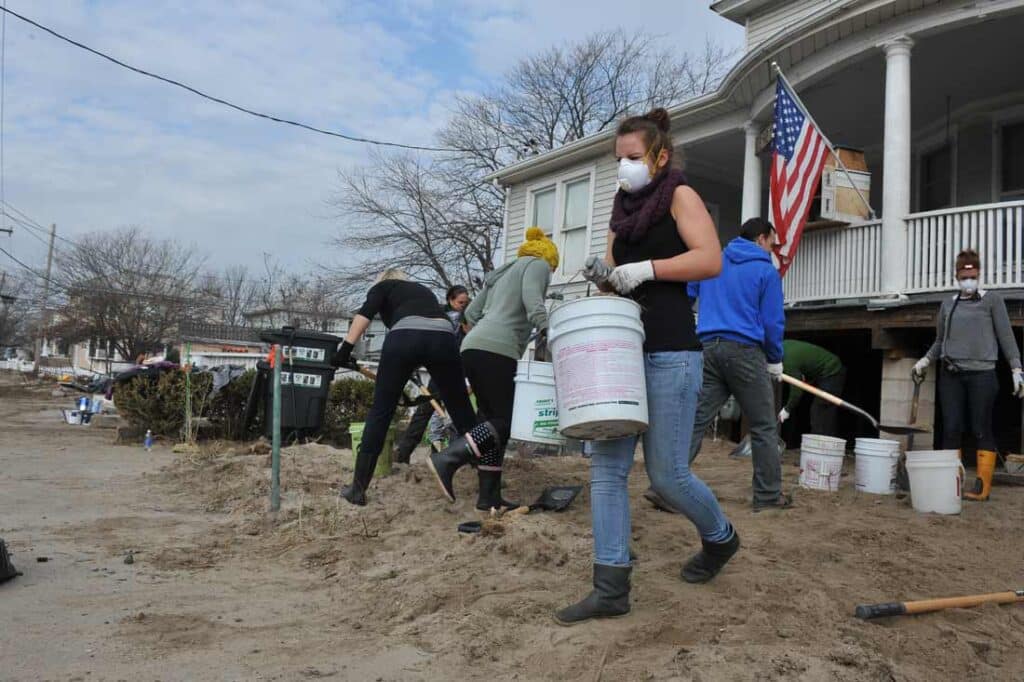 community members helping clear debris after a hurricane