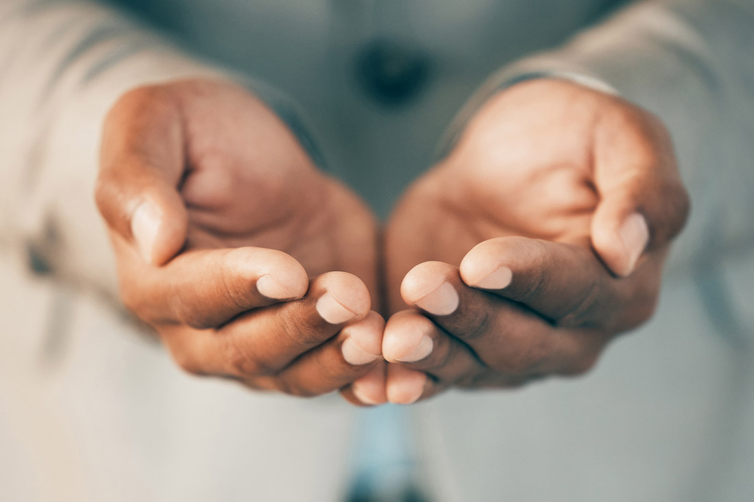 Hands held out for charity on Giving Tuesday