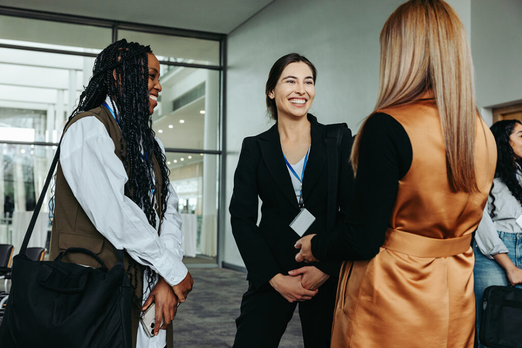 Three women shaking hands