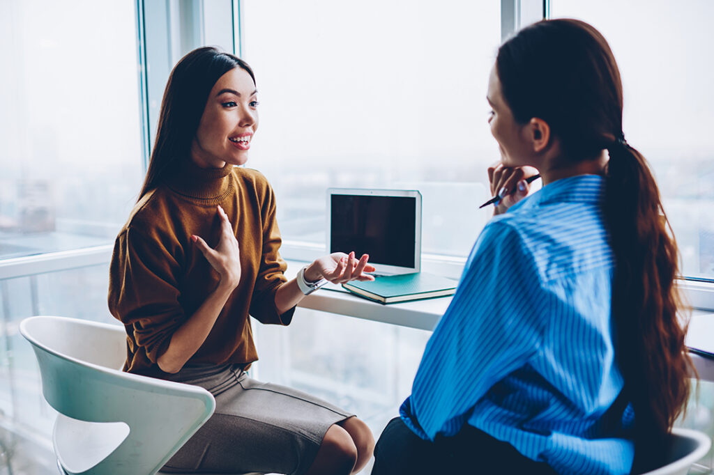 Two women talking to each other in an office