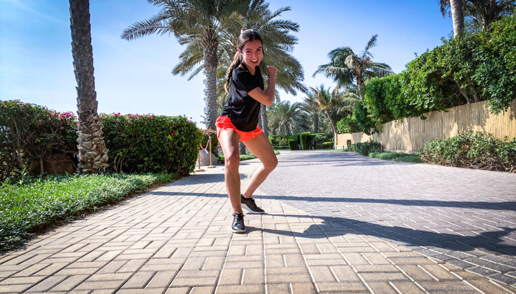 Menina Fortunato poses on a sidewalk.