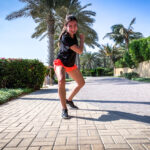 Menina Fortunato poses on a sidewalk.