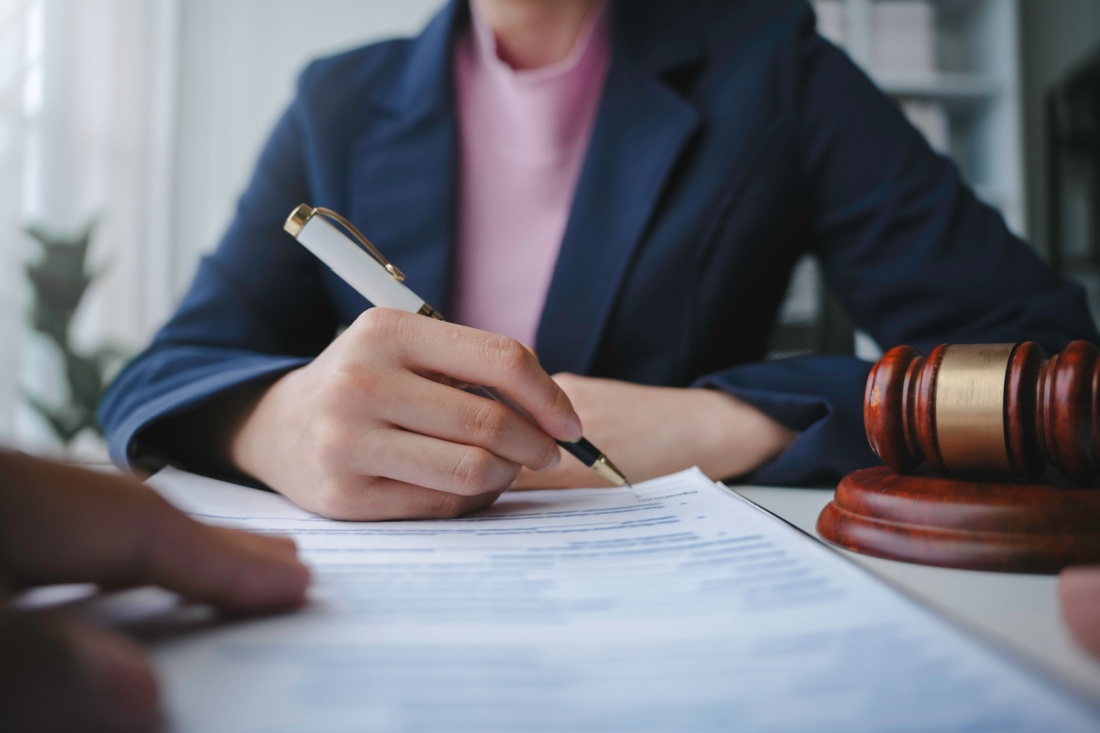 A woman signs a contract.