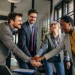 Happy colleagues give high five together