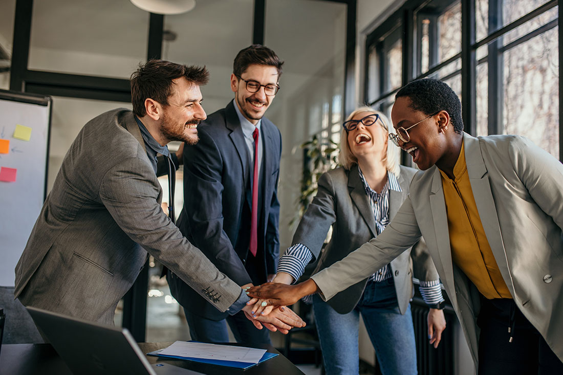 Happy colleagues give high five together