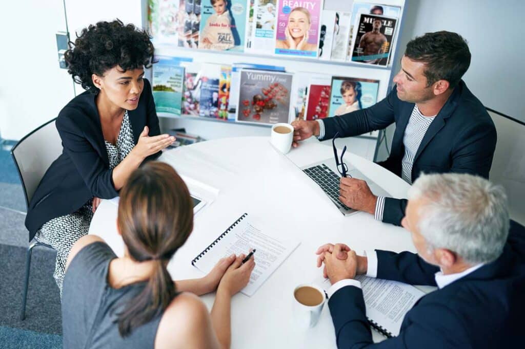 a group meeting of magazine staff discussing The Future of Editorial Jobs