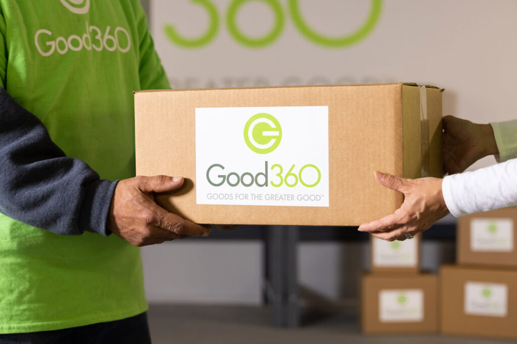 two people helping each other carry a good360 package